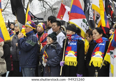 TORONTO - MARCH 10:  Tibetans listening to the speakers  during   a rally organized to protest against the Chinese occupation of Tibet on March 10 2009 in Toronto, Canada.
