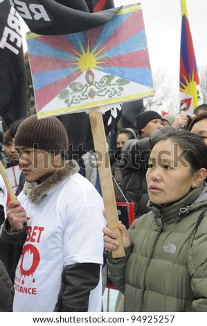 TORONTO - MARCH 10:  Grim looking marching in a rally organized to protest against the Chinese occupation of Tibet on March 10 2009 in Toronto, Canada.