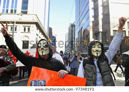 TORONTO -MARCH 11: Activists with guy fawkes mask during a protest against the 