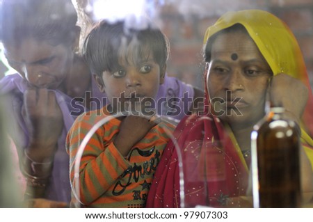 BHOPAL- DECEMBER 6: A mother along with her child waiting to get  medicine from a clinic dedicated to the Bhopal gas survivors and their families in Bhopal - India on December 6, 2010.
