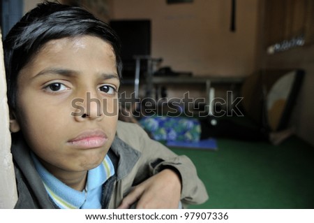 BHOPAL- DECEMBER 7:  11 years old Azhar suffering from cerebral palsy waiting eagerly inside a clinic for his ride to his home in  Bhopal - India on December 7, 2010.