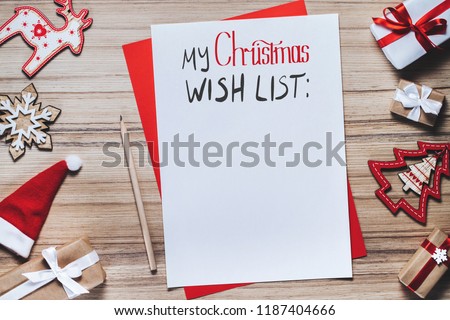 Border of pine tree toys with blank piece of paper and pencil to write x-mas wish list. Holiday concept. Christmas composition.