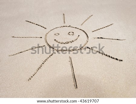 sun symbol written in the sand on  costa rican tropical beach with smiley face