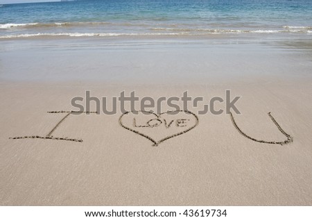 love heart symbol and letters spelling i love you on tropical beach