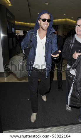 LOS ANGELES - JANUARY 26 : Actor Ryan Gossling is seen all smiles in a hooded jacket as he arrives at LAX airport. January 26, 2010 in Los Angeles, California
