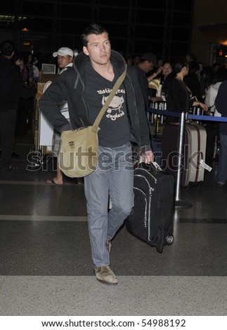 LOS ANGELES - MARCH 12: Australian actor Sam Worthington is seen at LAX. March 12th in Los Angeles, California.