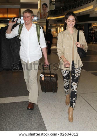 LOS ANGELES-MAY 5: Actress Emmy Rossum with boyfriend Tyler Jacob Moore at LAX airport. May 5 in Los Angeles, California 2010