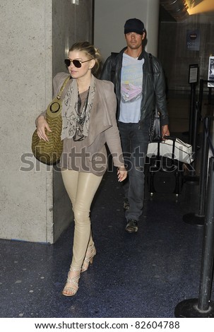 LOS ANGELES-MAY 25: Singer Fergie with husband Josh Duhamel at LAX airport. May 25 in Los Angeles, California 2010