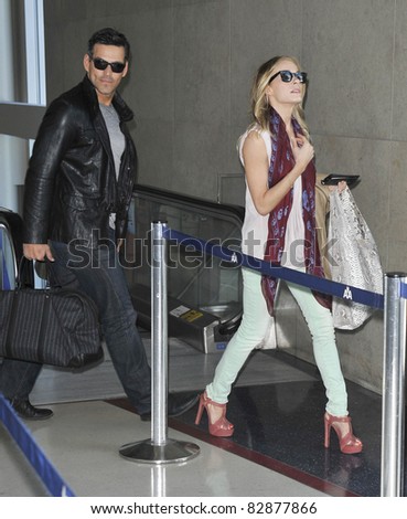 LOS ANGELES-MARCH 28: Singer Leanne Rhimes with husband Eddie Ciprian at LAX airport. March 28, 2011 in Los Angeles, California
