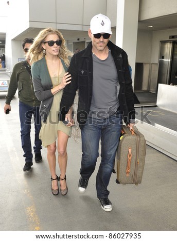LOS ANGELES-MAY 05: Actor Eddie Ciprian and Leanne Rimes at LAX airport. May 05 in Los Angeles, California 2011