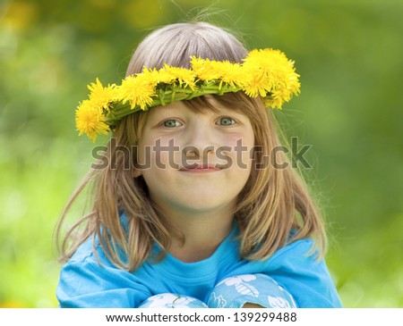 portrait of a boy with long blond hair and  flower wreaths