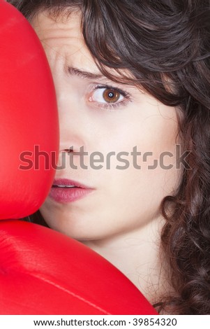 fearful young woman with red boxing gloves