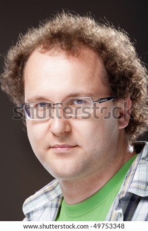 stock photo : portrait of a young man with curly hair and glasses - isolated 