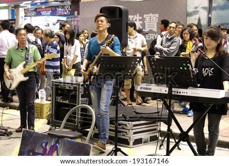 HONG KONG - OCTOBER 27,2013 : Street singers in Mongkok at night on October 27, 2013 in Hong Kong. Singers' competition for space on the street has created disturbance and noise pollution problems.