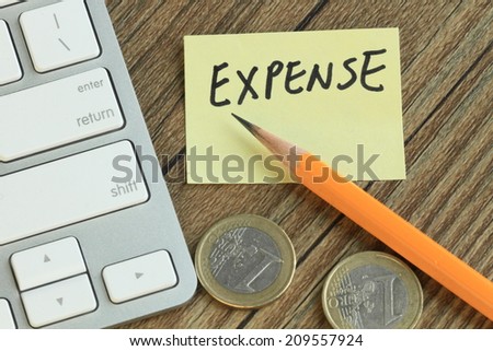 concept of expense, with stationery and money in the background