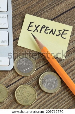 concept of expense, with stationery and money in the background