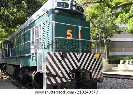 HONG KONG -JULY 16, 2014: Retired historical green train at Tai Po on July 16, 2014 in Hong Kong. This historical diesel locomotive is parked at the only railway museum in Hong Kong.