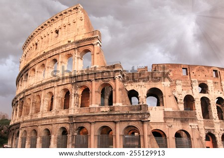 Colosseum in Rome with sunbeam after storm