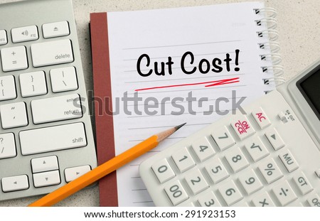 concept of cut cost, with calculator and desk background