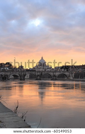 view of Vatican reflected on Tiber river in Rome at sunset
