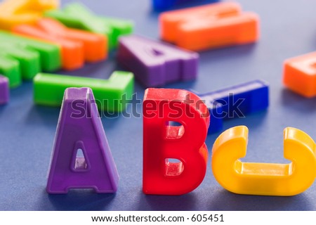 plastic colored letters with some out of focus in the background