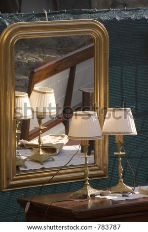 antique lamps and mirror with reflection