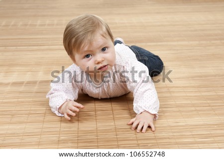 happy baby girl lying on the floor