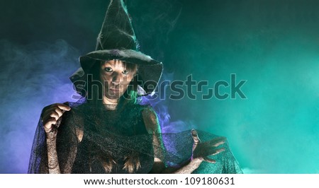 Halloween witch, green and blue smoke background