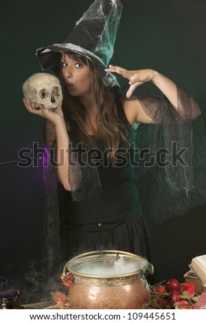 halloween witch with skull and cauldron