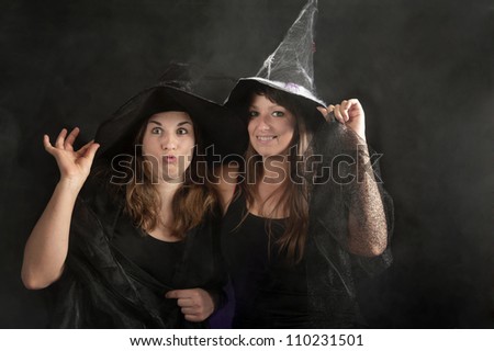 two halloween witches on dark background