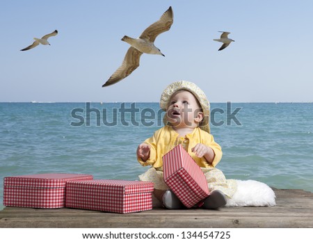 little baby girl with vintage suitcases on an old wooden raft floating in the sea, seagulls above her head