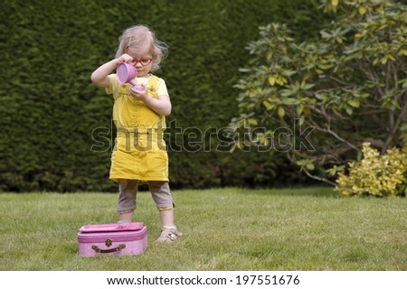 little toddler playing tea time in the garden