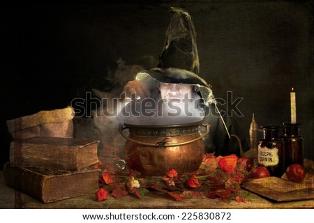 evil halloween witch making a potion in a copper cauldron