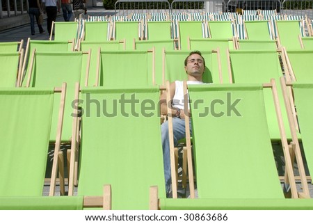 young adult man sunbathing in a deckchair