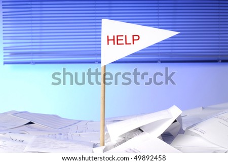 flag with help sticking out of desk full of papers