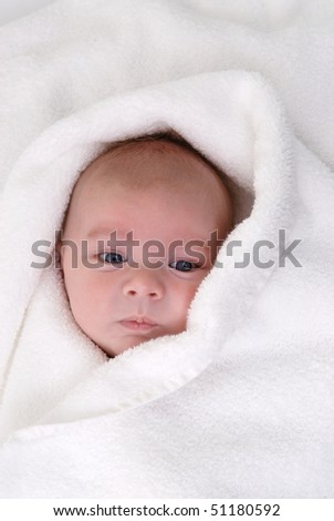 baby wrapped in white towel