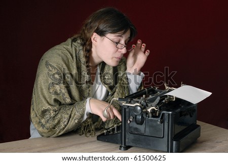 female author typing on an old typewriter