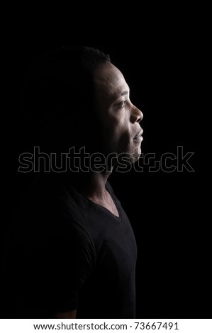 profile of young black man. isolated on black background