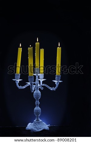 candle holder and burning candles on dark background