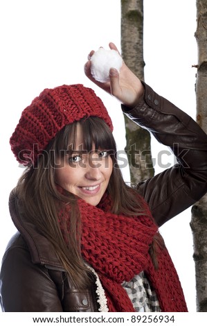 young woman with red cap and shawl throwing a snow ball