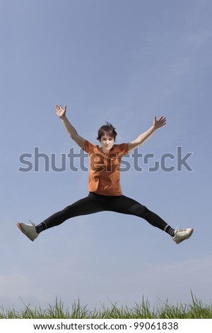 Mid adult woman jumping in the air