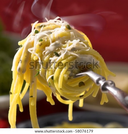 fresh hot  spaghetti  with cheese on fork  with vapor, closeup, square format