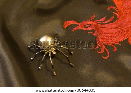 brooch in the form of a spider on the traditional Chinese embroidery on black silk