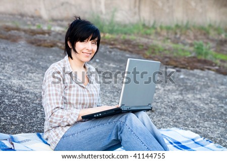 Woman working on laptop outdoor