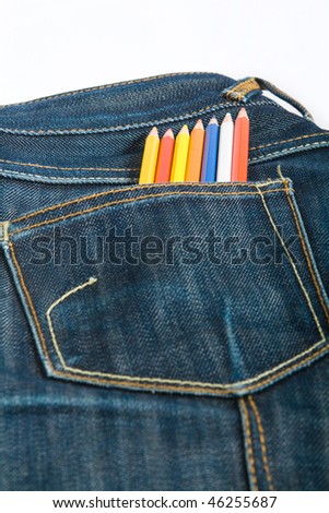 denim pocket with color pencils set on white background
