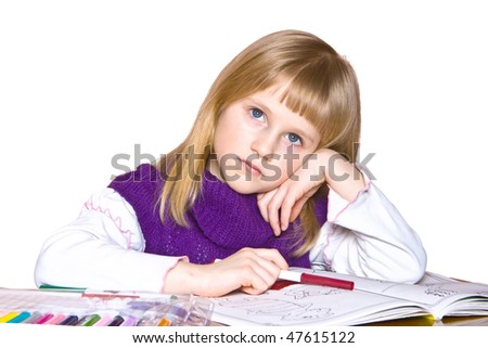 Little girl thinking and drawing in the book, isolated on white