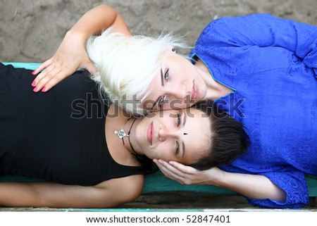 Portraits of two young women on the bench, top view