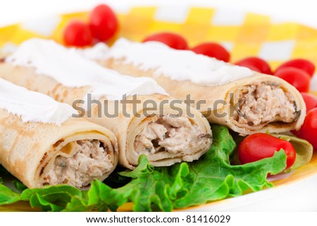 Pancakes with the chicken, lettuce, and tomatoes on the yellow plate