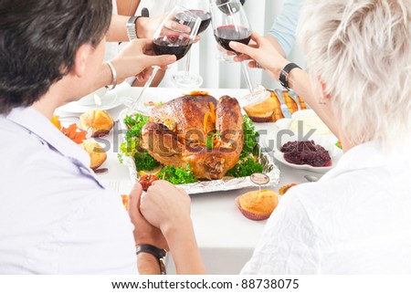 Family members giving thanks to God at festive table while holding each other by hands, close-up