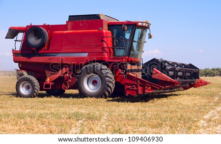 Red combine on field